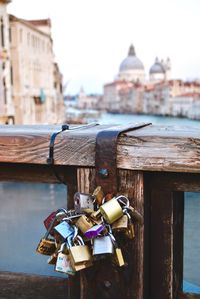 Padlocks on bridge against grand canal in city