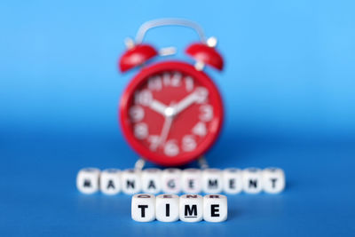 Close-up of clock against blue background