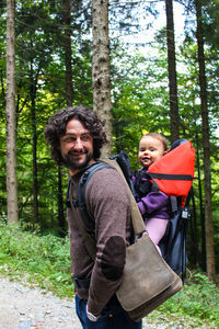 Portrait of smiling young man in forest