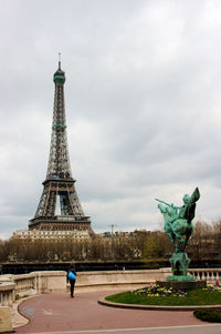 Statue of tower against cloudy sky