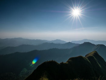 Scenic view of mountains against bright sun