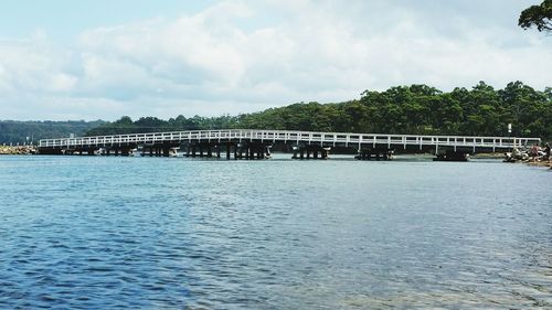 Scenic view of river against cloudy sky