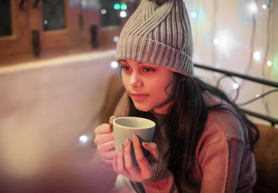 Portrait of woman drinking coffee at restaurant