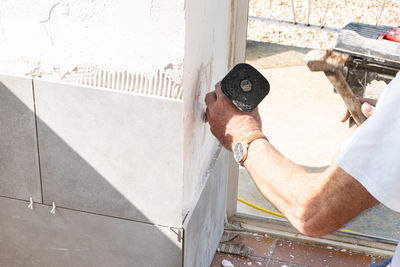 High angle view of man working against wall