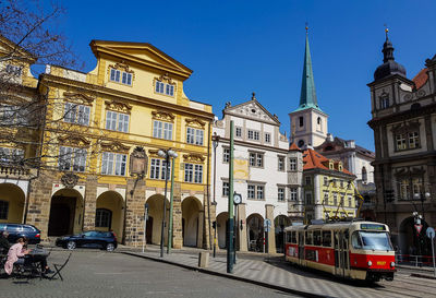 View of city street and buildings against sky