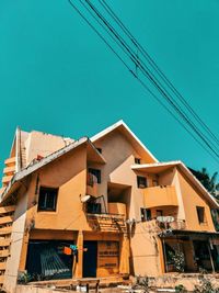 Low angle view of buildings against clear blue sky