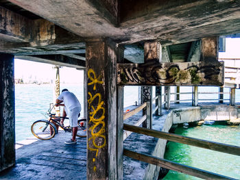 Man cycling on bicycle by water