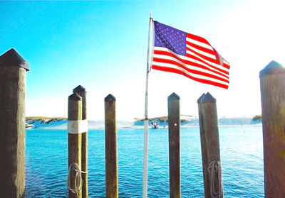 Close-up of flag against blue sea