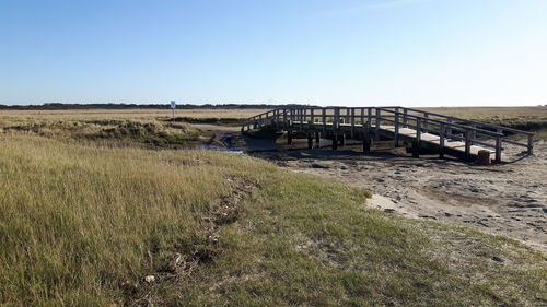 View of bridge on field against clear sky