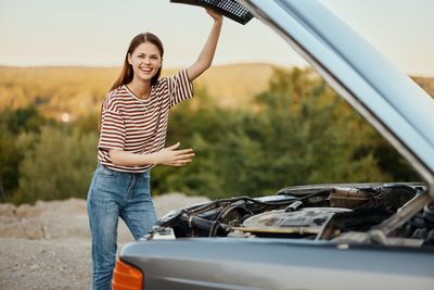 Portrait of young man holding car