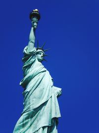 Low angle view of statue of liberty against sky