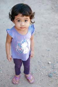 Portrait of cute girl standing on land