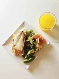 High angle view of food in plate against white background