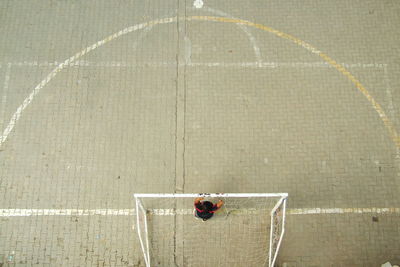 Directly above shot of man standing at goal post