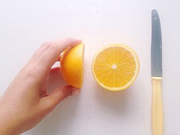 Cropped image of hand holding apple