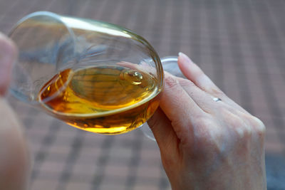 Close-up of hand holding ice tea