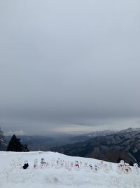 Scenic view of snow covered mountains against sky