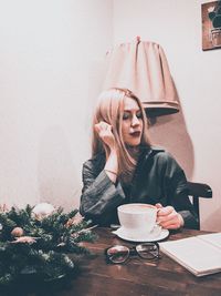 Portrait of young woman with coffee