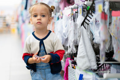 Portrait of cute boy standing in store