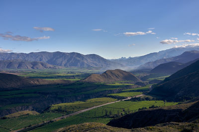 Scenic view of landscape and mountains against sky