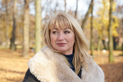 Woman sitting on bench in park