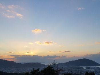 Scenic view of silhouette mountains against sky at sunset