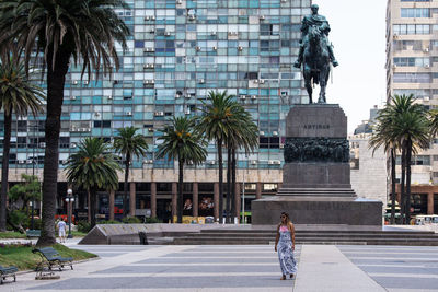 Rear view of a statue against building in city