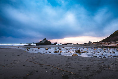 Scenic view of rock formation in sea against sky