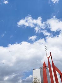 Low angle view of flag on building against sky