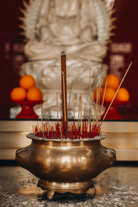 Burning incense in a golden vat in a buddhist temple. thai traditions and rituals