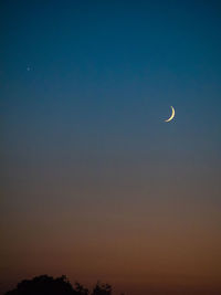 Low angle view of silhouette moon against sky at night