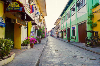 Empty alley amidst buildings in city