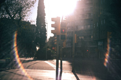 Street amidst buildings in city seen through glass window