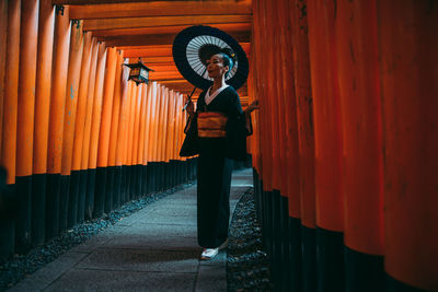 Full length of woman standing at temple