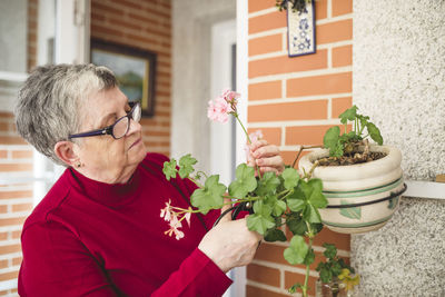 Senior woman taking care of her plants