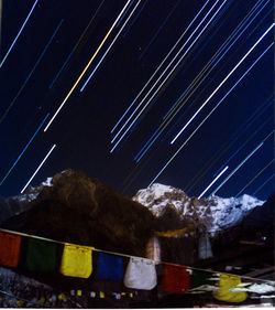 Aerial view of illuminated mountains against sky at night