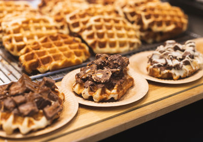 Belgian waffles with chocolate in plates on display.