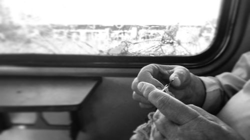 Close-up of person weaving in car 