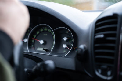 Cropped hand of man driving car