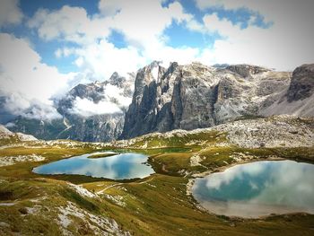 Scenic view of mountains against cloudy sky