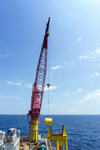 Anchor buoy being lifted from a construction barge at oil field during anchor handling job