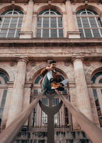 Low angle view of man standing outside building