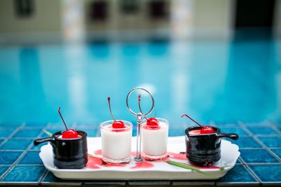 Dessert in tray against swimming pool