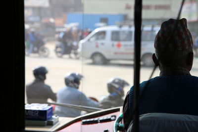 Rear view of people sitting on street