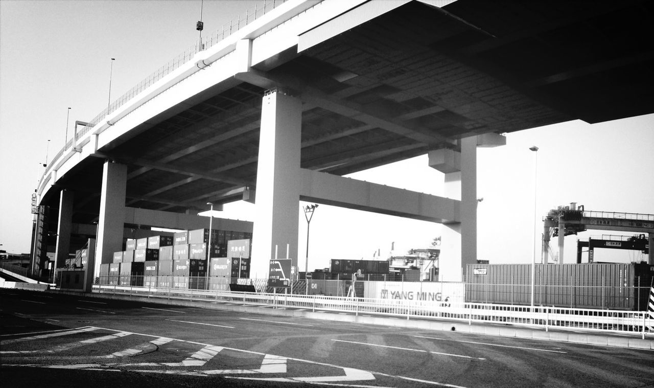 transportation, architecture, built structure, road, road marking, building exterior, street, city, connection, bridge - man made structure, car, clear sky, the way forward, land vehicle, mode of transport, sky, day, outdoors, engineering, road sign