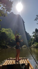 Full length of man standing by lake against sky