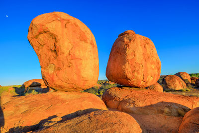 Low angle view of rock formation against blue sky