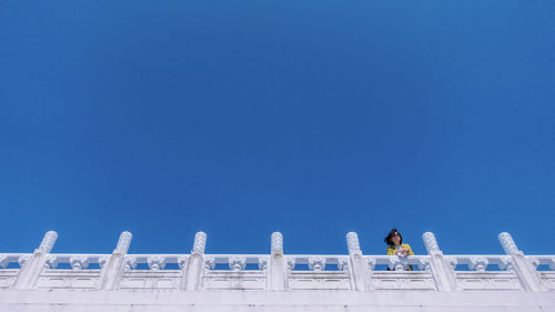 Low angle view of building against clear blue sky