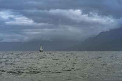 Sailboat in sea against sky