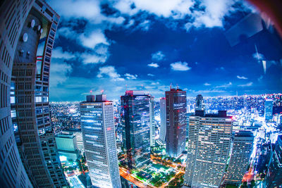 High angle view of illuminated buildings against sky in city